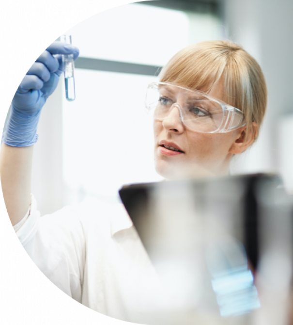 Two laboratory technicians, one of them is looking to a sample Two laboratory technicians, one of them is looking to a sample