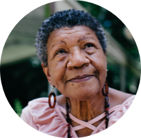 An old woman smilling and looking up