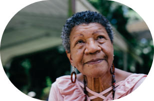 An old woman smilling and looking up