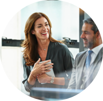 Two people in an office smilling
